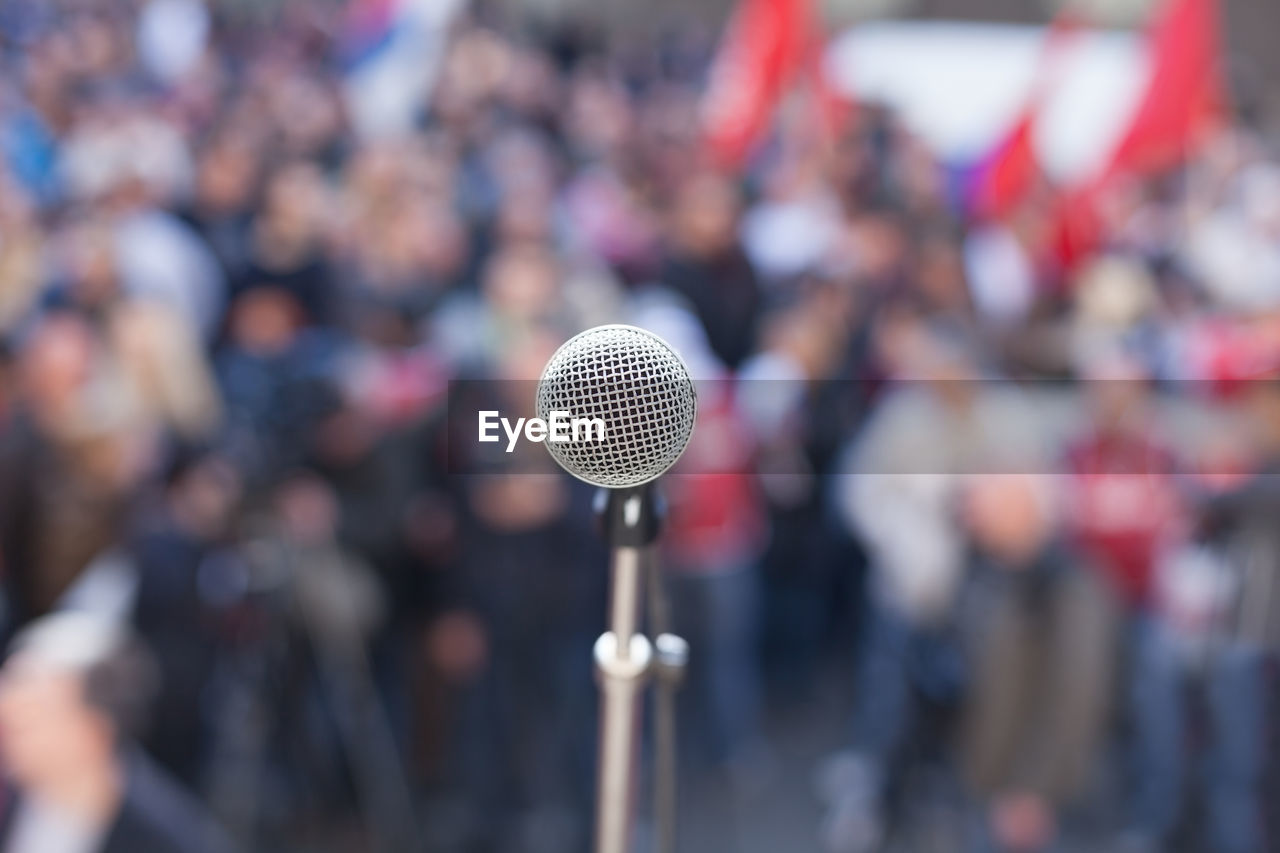 Close-up of microphone against crowd
