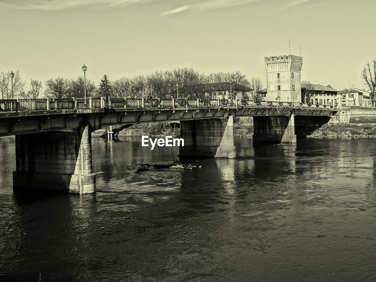 Bridge over calm lake against the sky