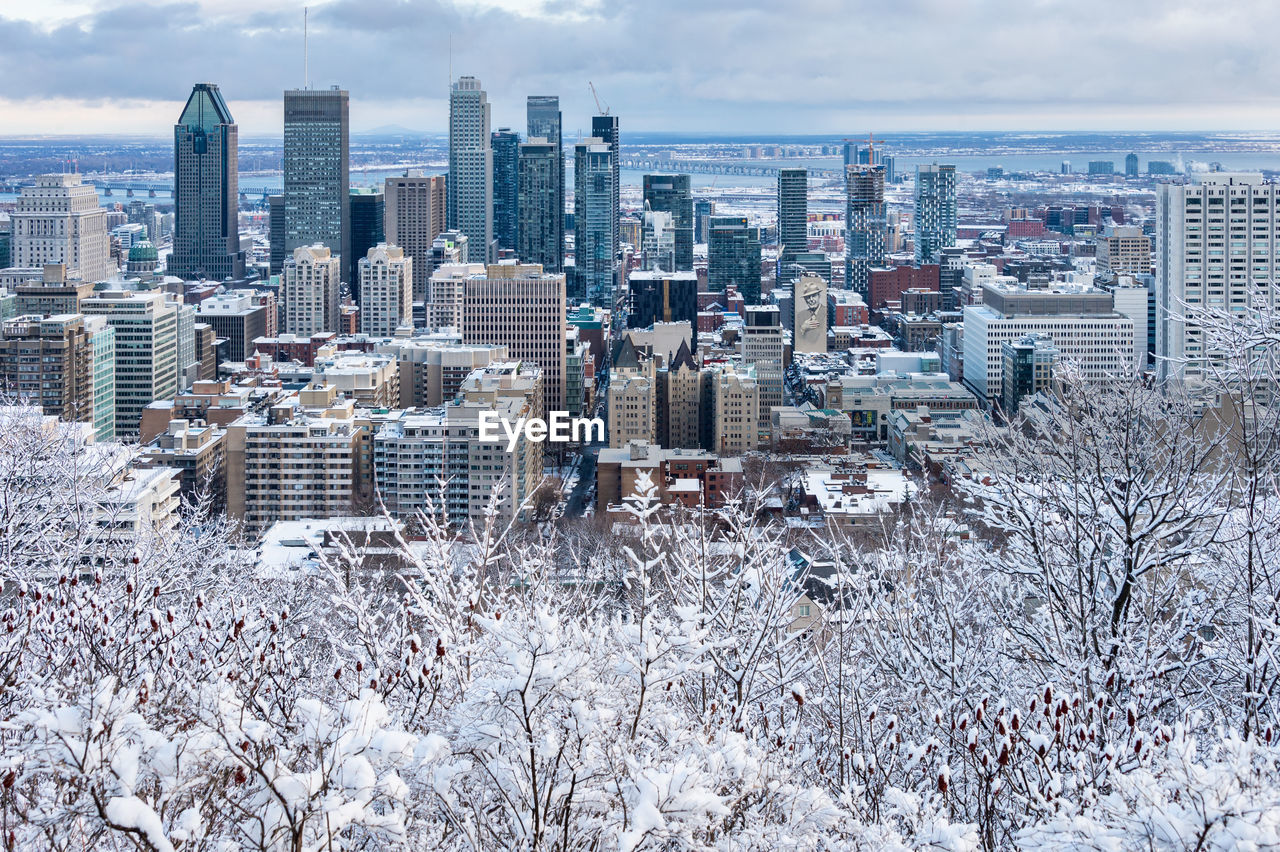 Aerial view of buildings in city during winter