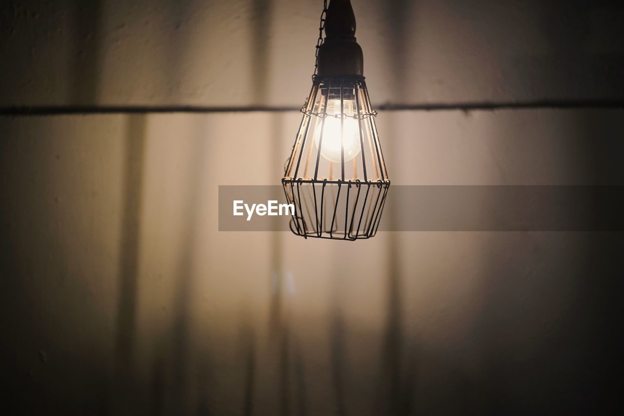 Close-up of illuminated light bulb in darkroom