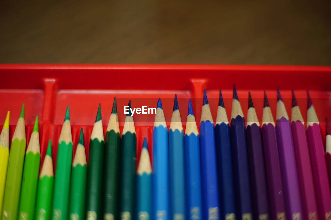 Close-up of multi colored pencils in container