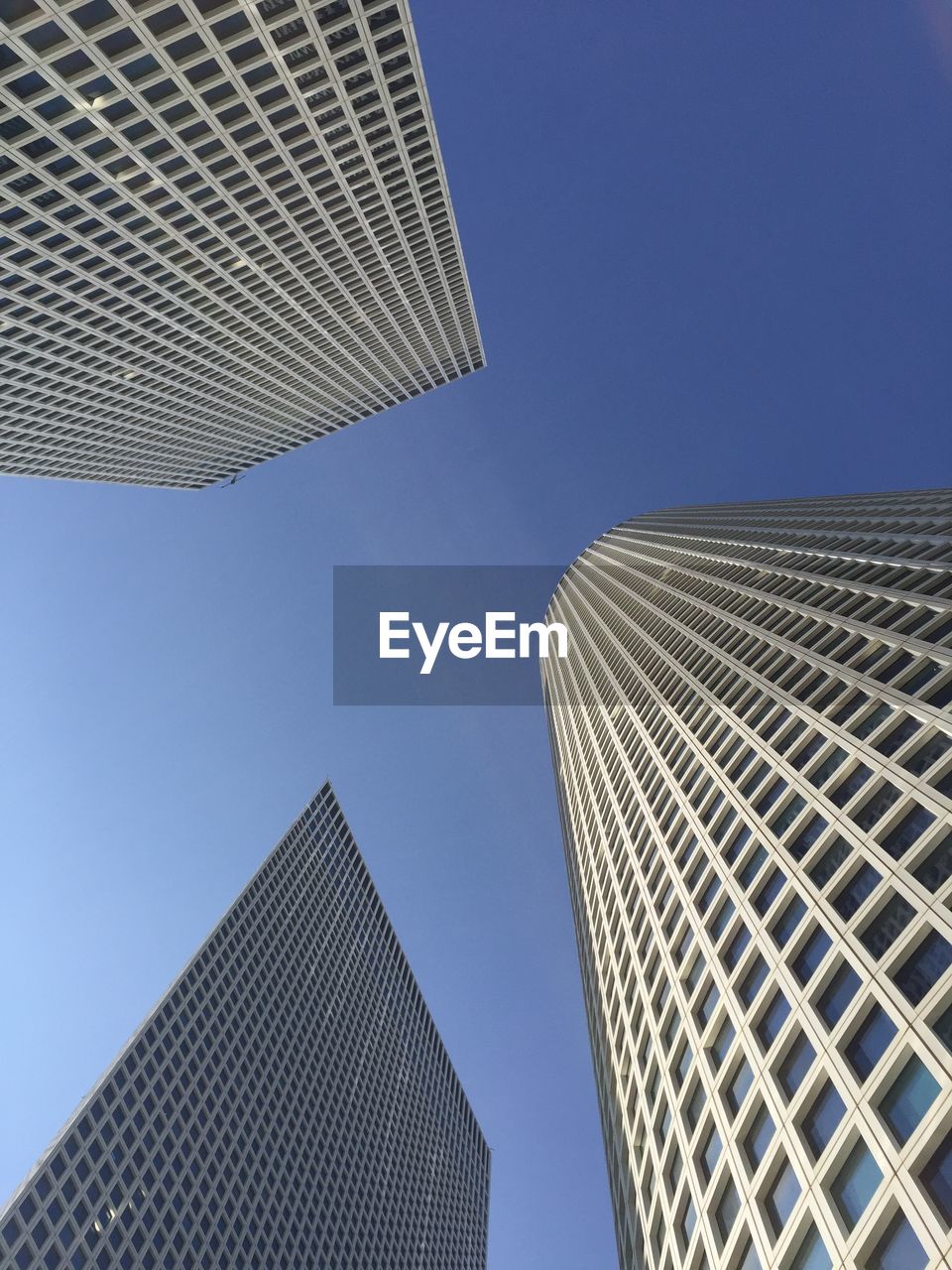 architecture, built structure, building exterior, skyscraper, office building exterior, city, sky, building, office, low angle view, clear sky, blue, line, no people, tower block, tower, day, facade, business, nature, ceiling, glass, pattern, sunlight, light, outdoors, landmark, roof, sunny, downtown district, daylighting, city life