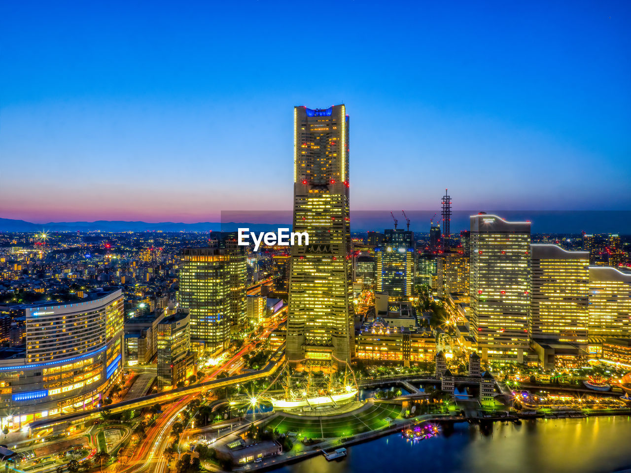 High angle view of illuminated cityscape against sky at night