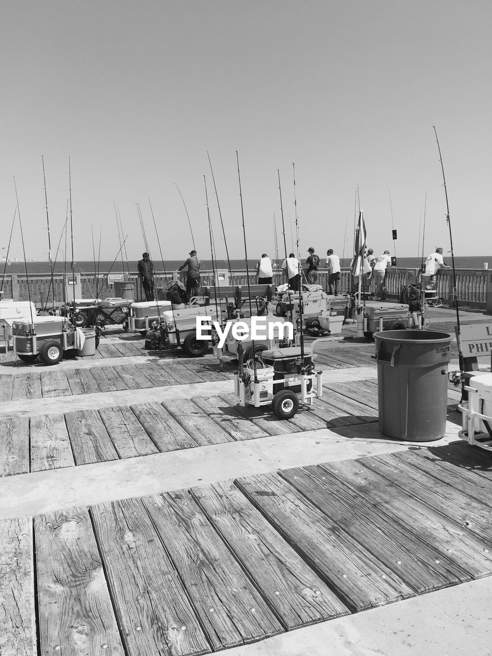 Boats moored at harbor against clear sky