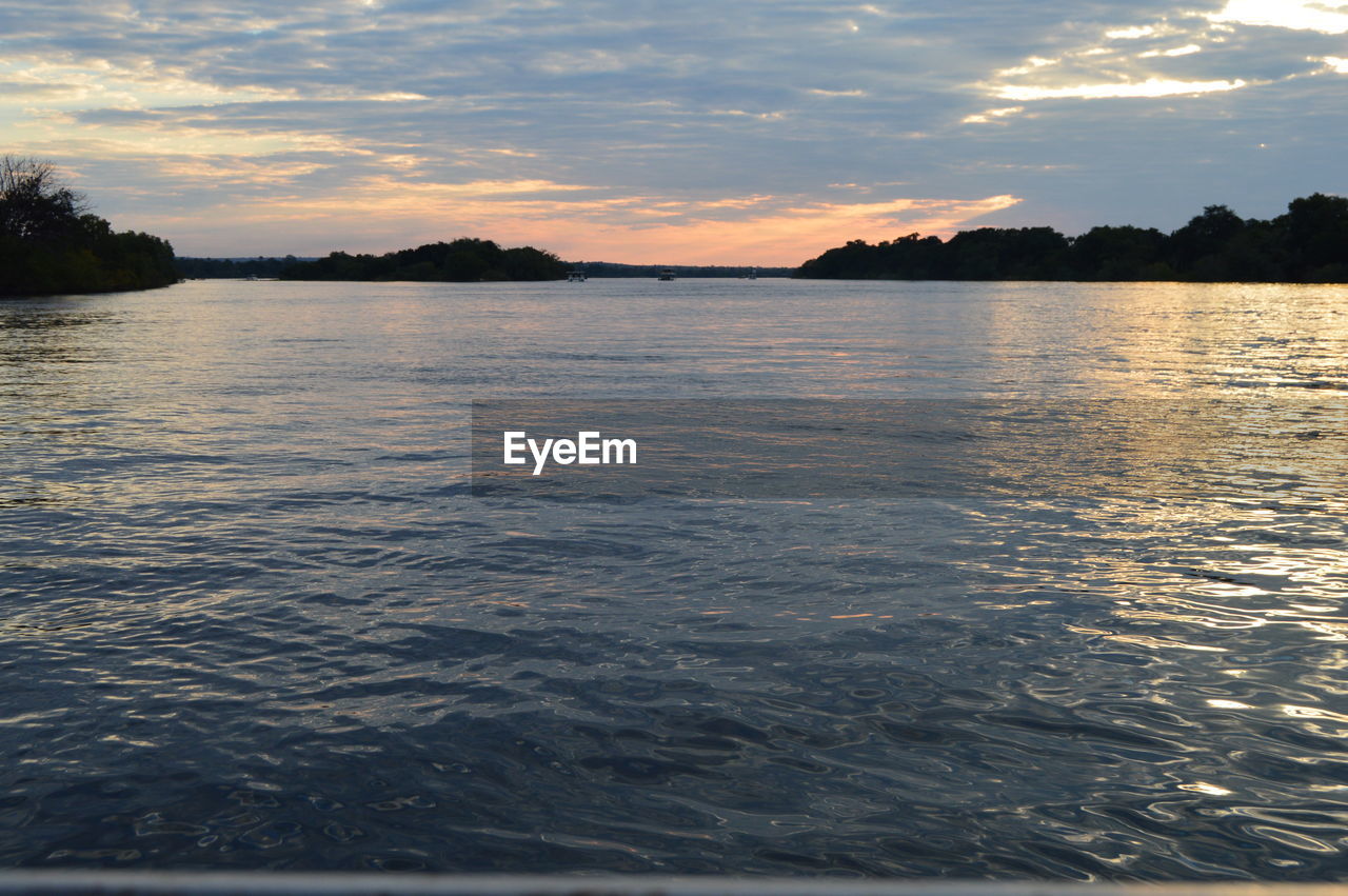 SCENIC VIEW OF LAKE AT SUNSET