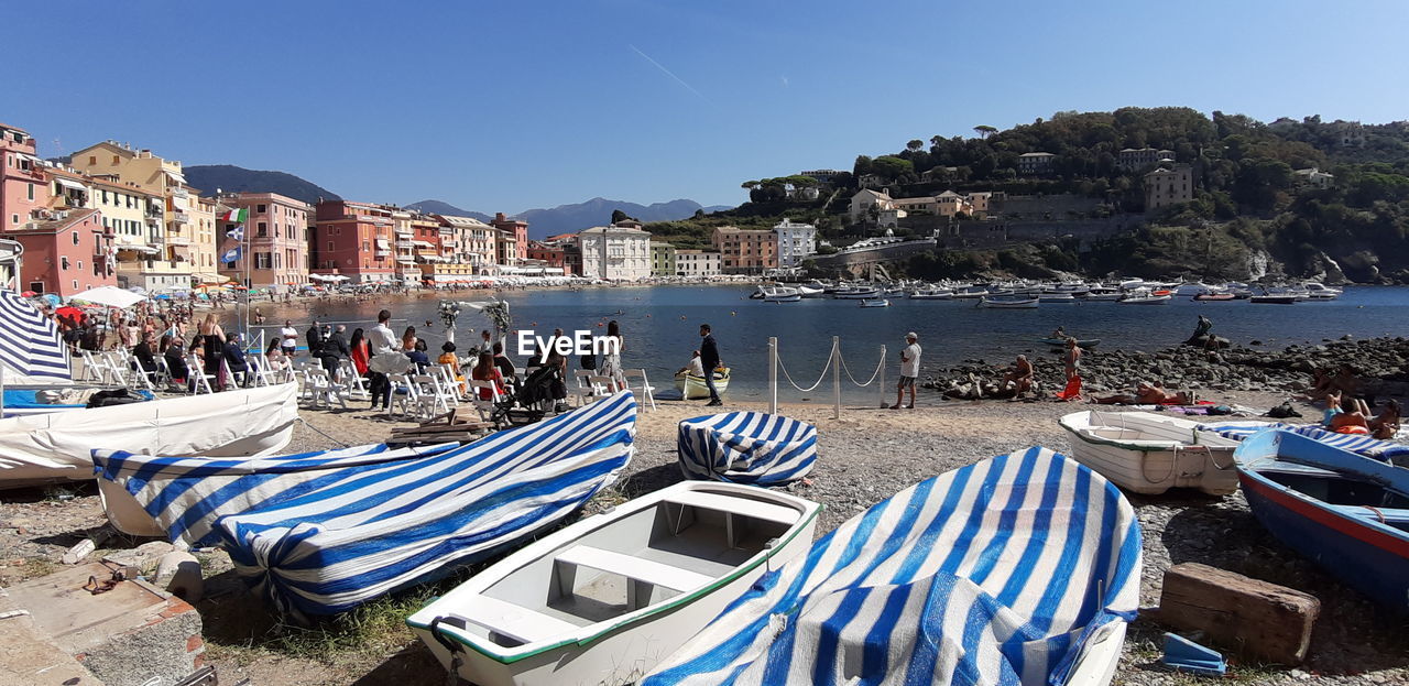 PEOPLE ON BEACH AGAINST BLUE SKY