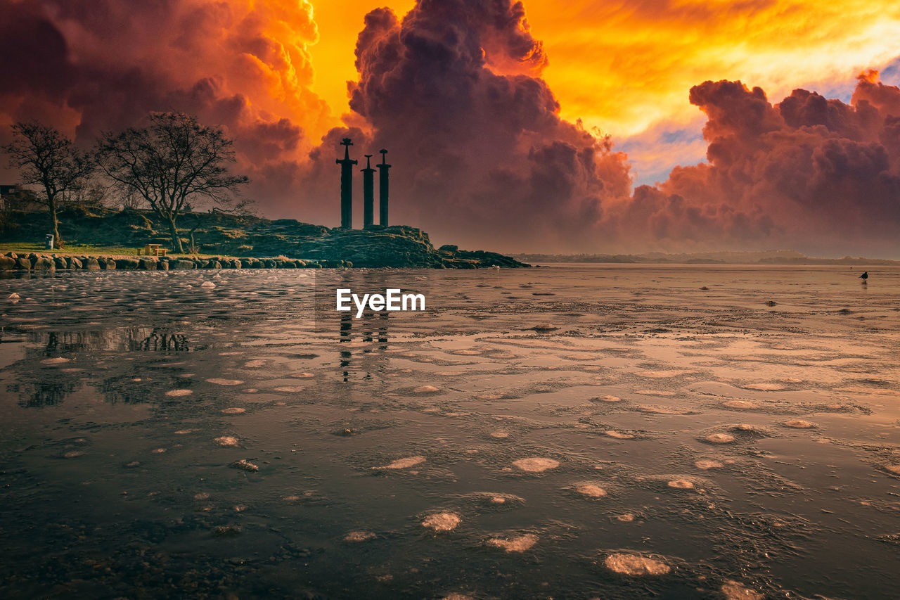 SCENIC VIEW OF BEACH DURING SUNSET