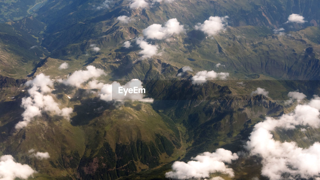 High angle view of land and mountains against sky