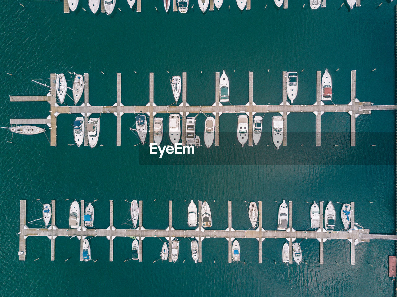 Aerial view of boats moored at harbor on sea