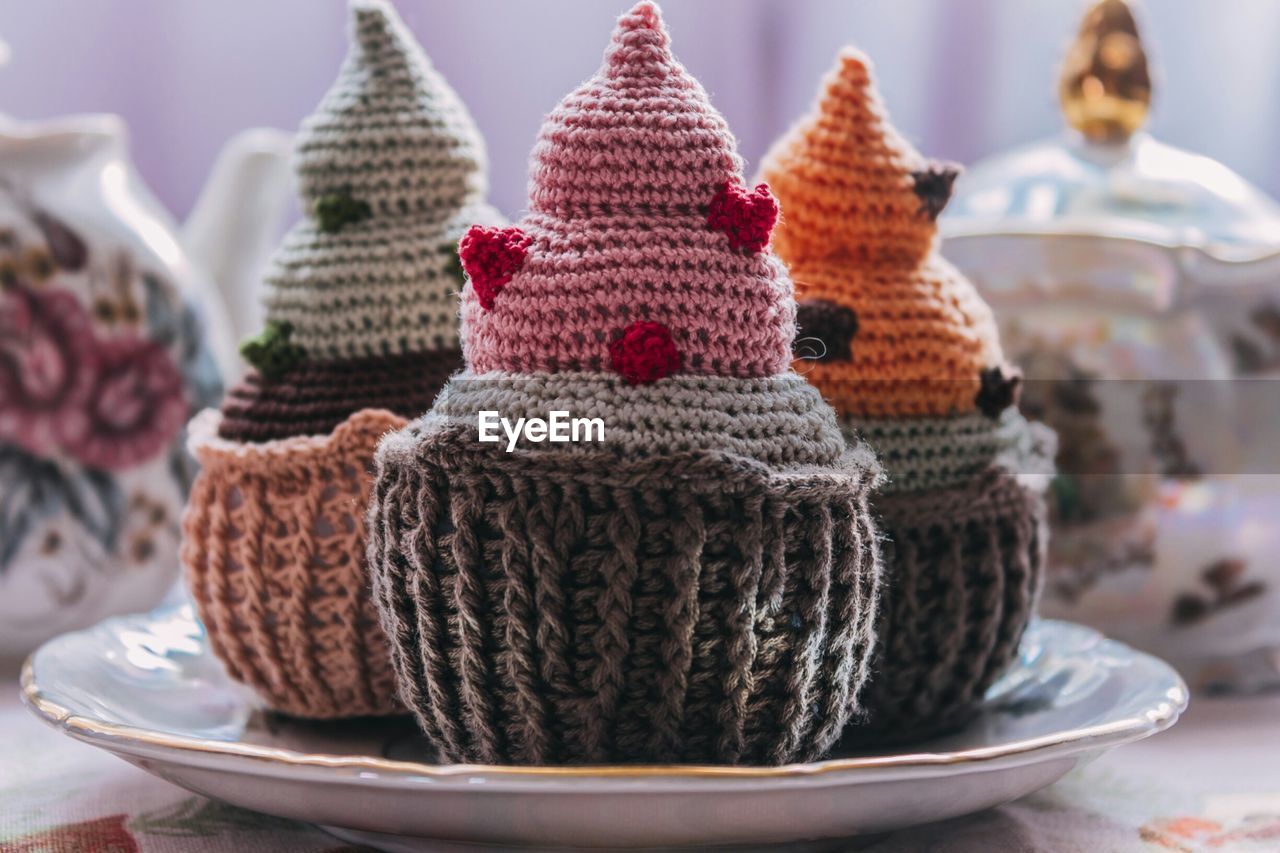 Close-up of crochet cupcakes in plate