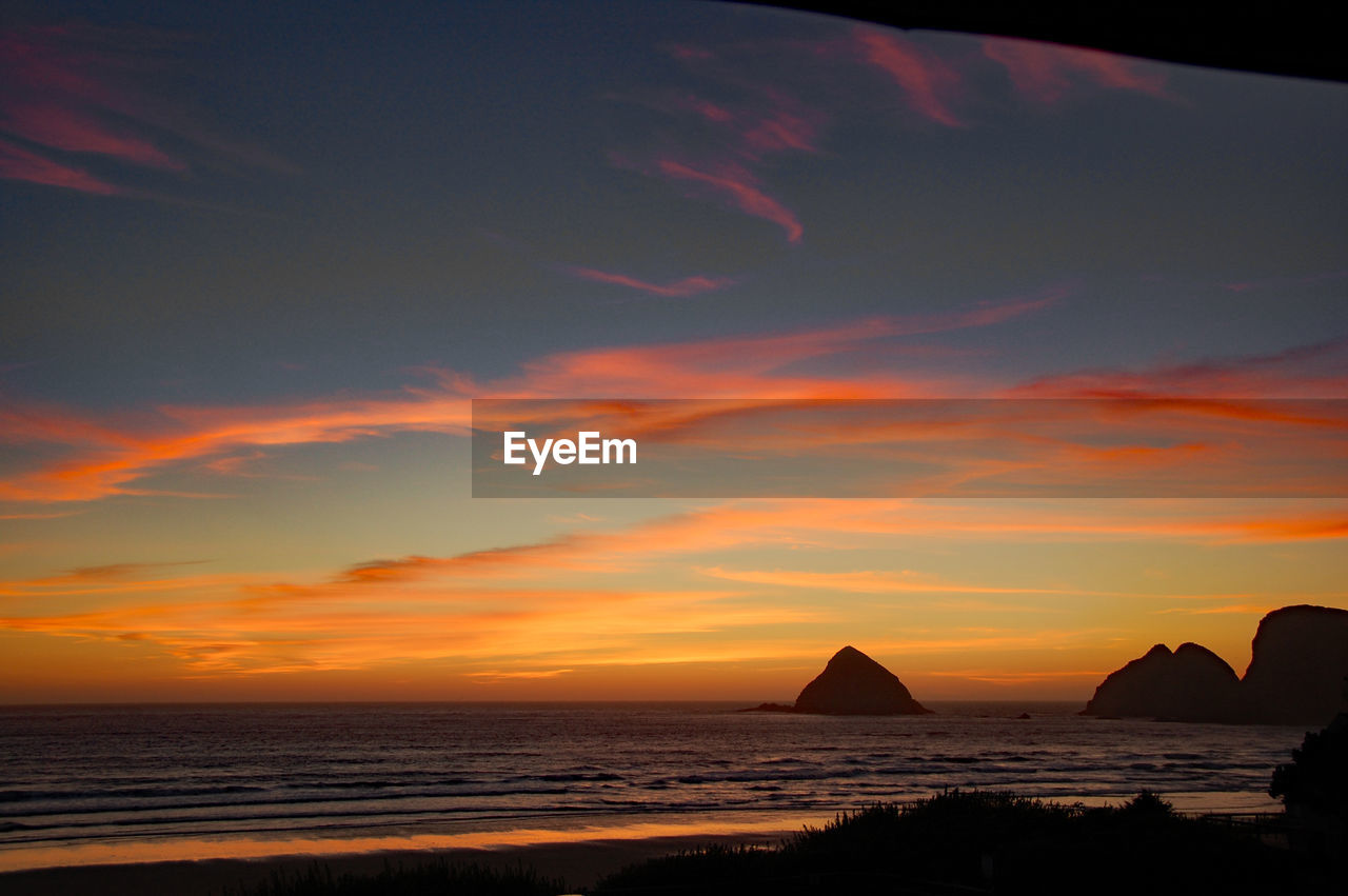 Scenic view of sea against dramatic sky