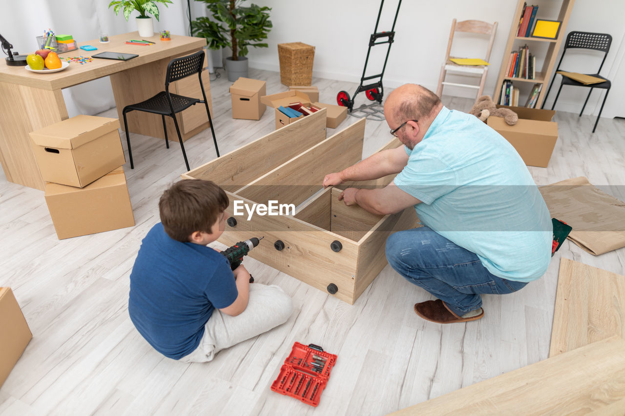 high angle view of boy playing with toy blocks