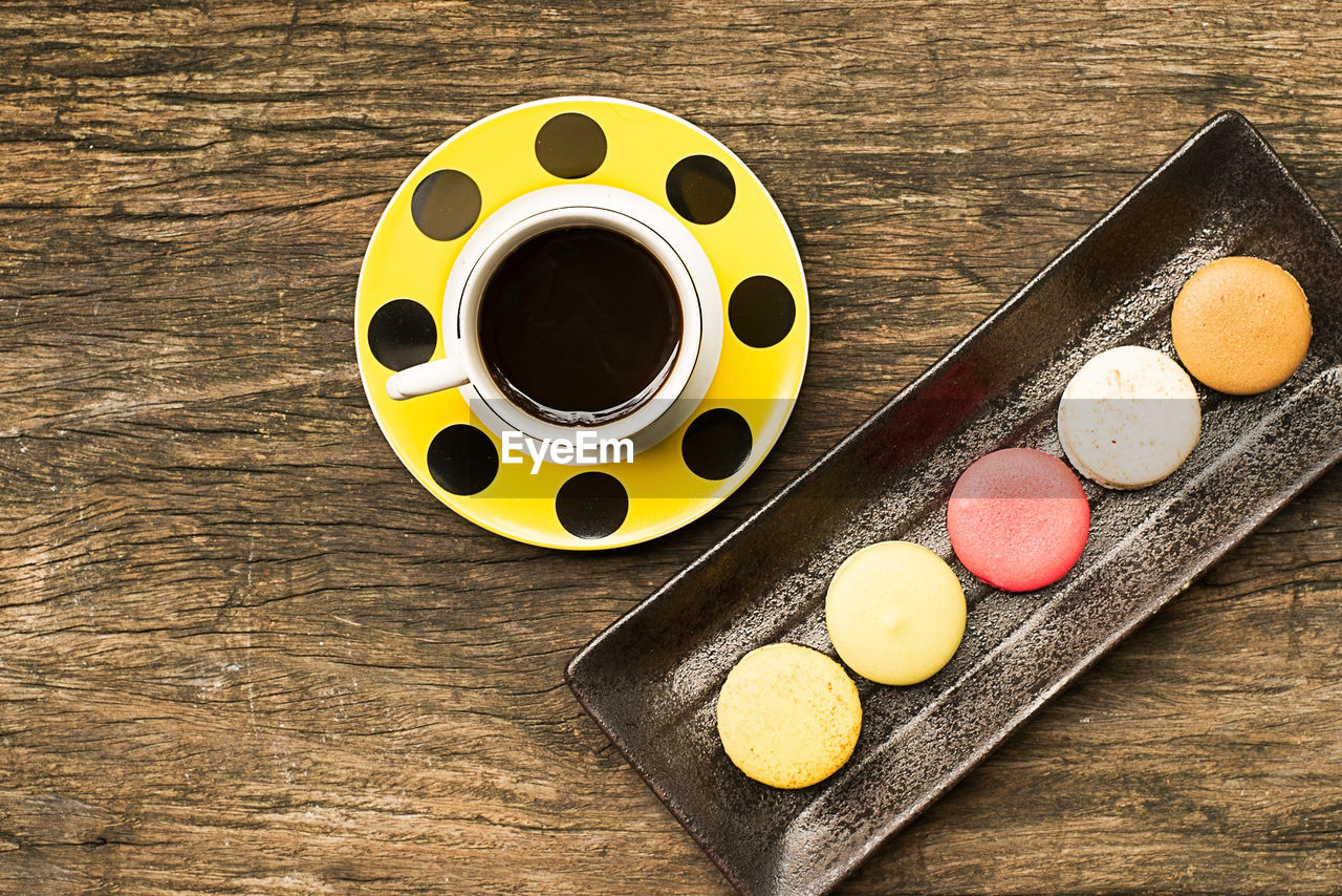 Colorful and delicious french macaron cookies varieties on a wooden table