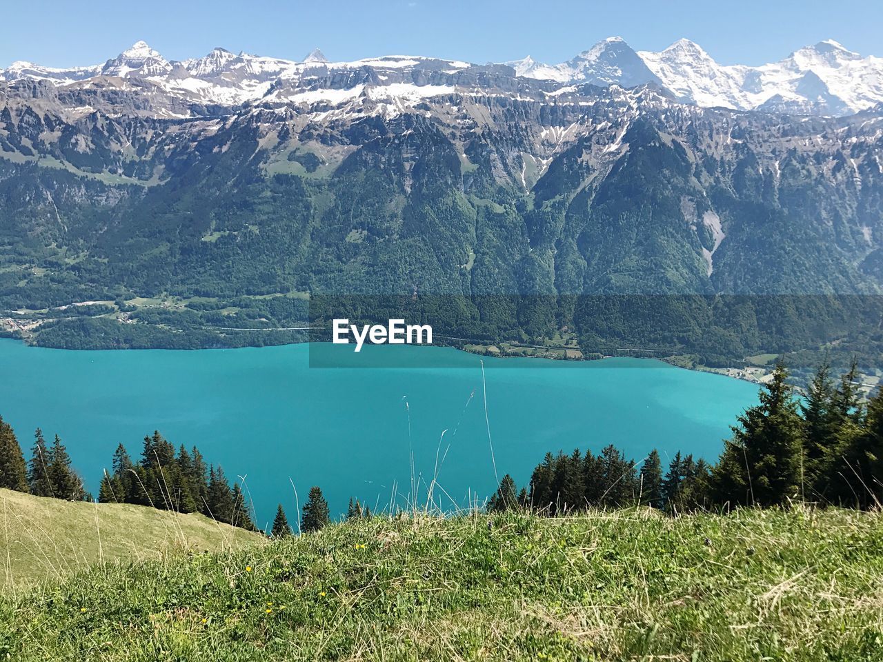 Scenic view of lake and mountains against blue sky