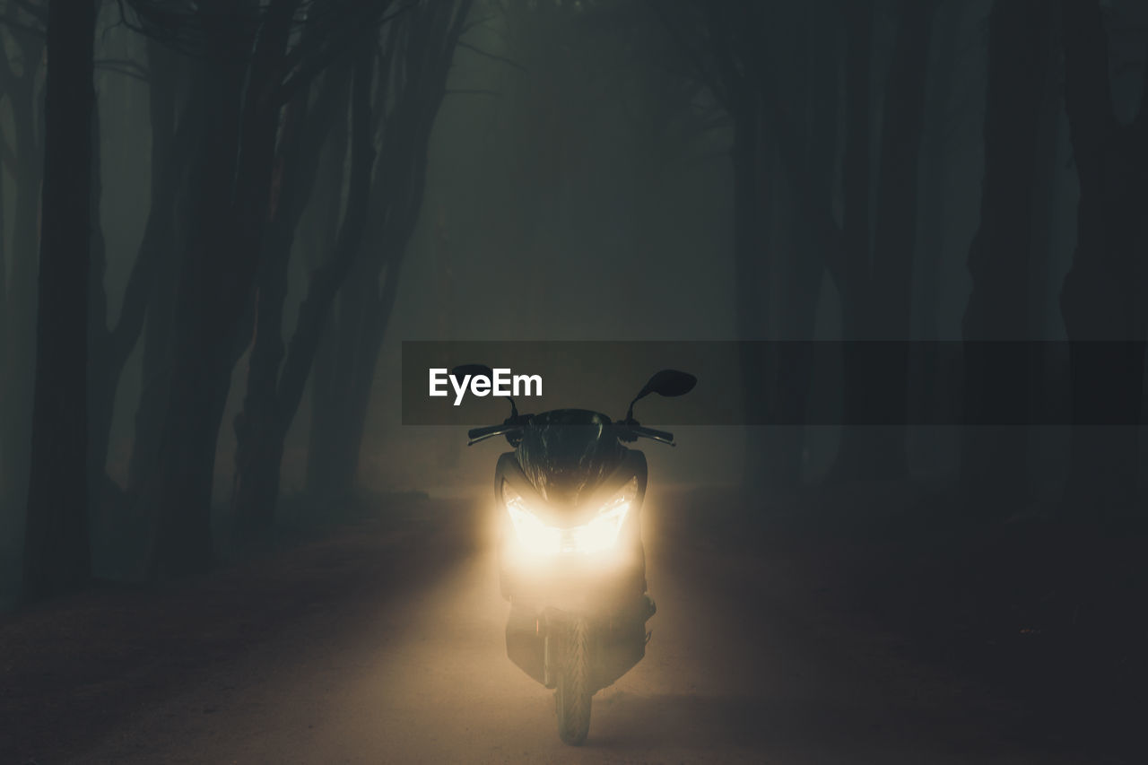 Silhouette of a motorcycle in the forest