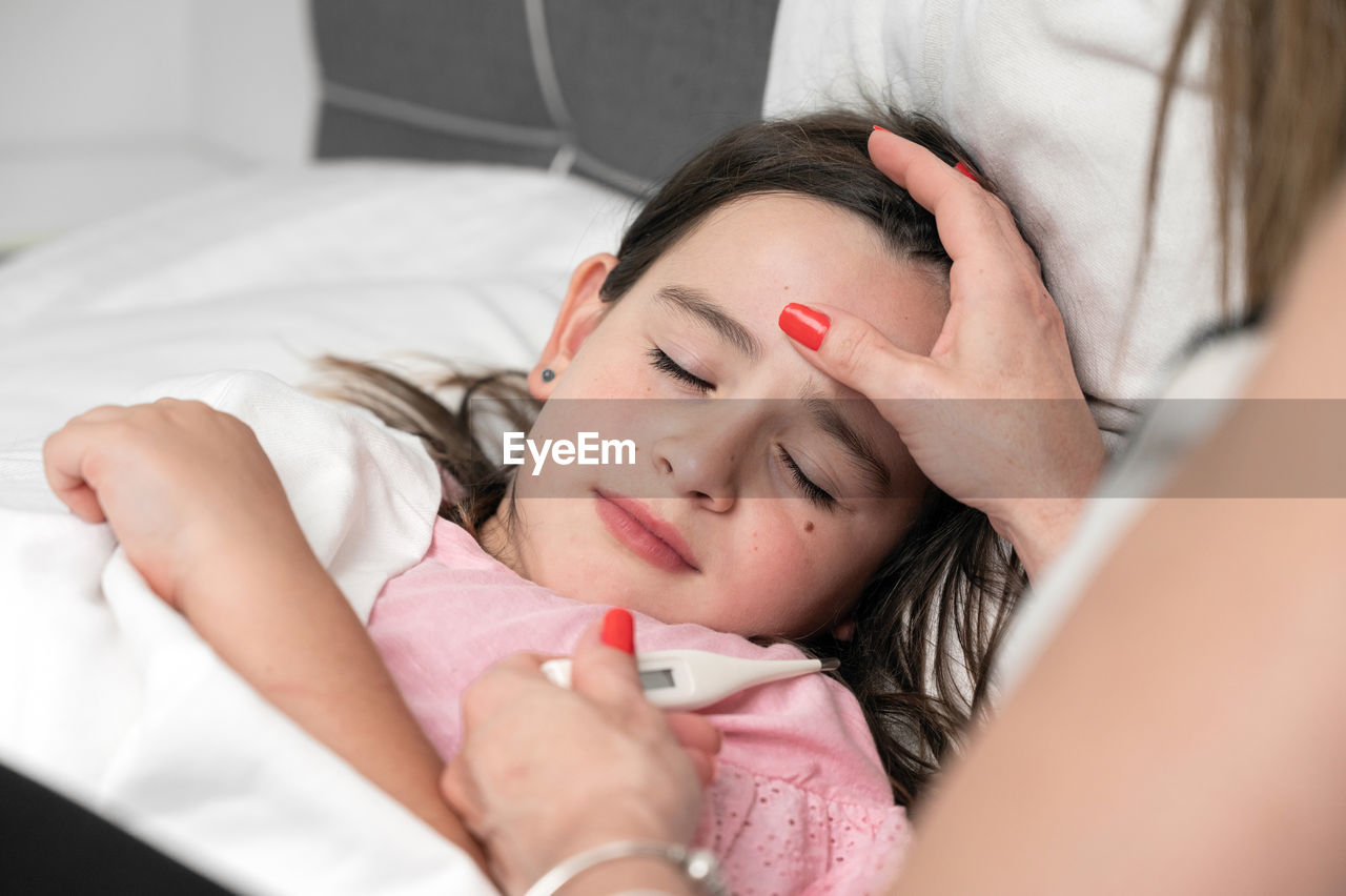 high angle view of young woman sleeping on bed at home