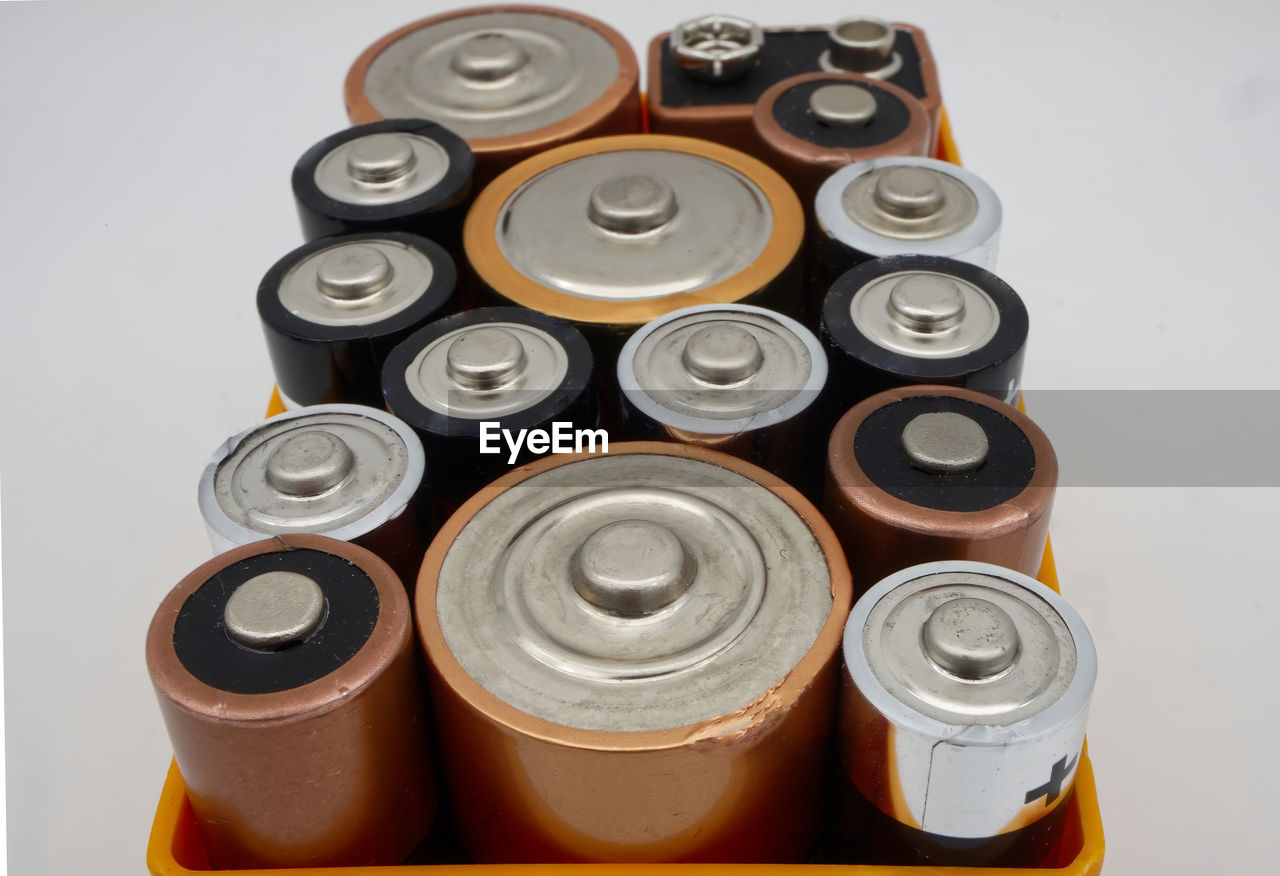 Batteries of different sizes and formats in a box, selective focus.