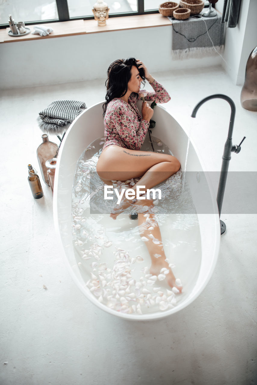 High angle view of beautiful woman relaxing in bathtub
