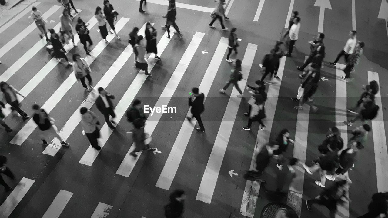 HIGH ANGLE VIEW OF PEOPLE WALKING ON STREET