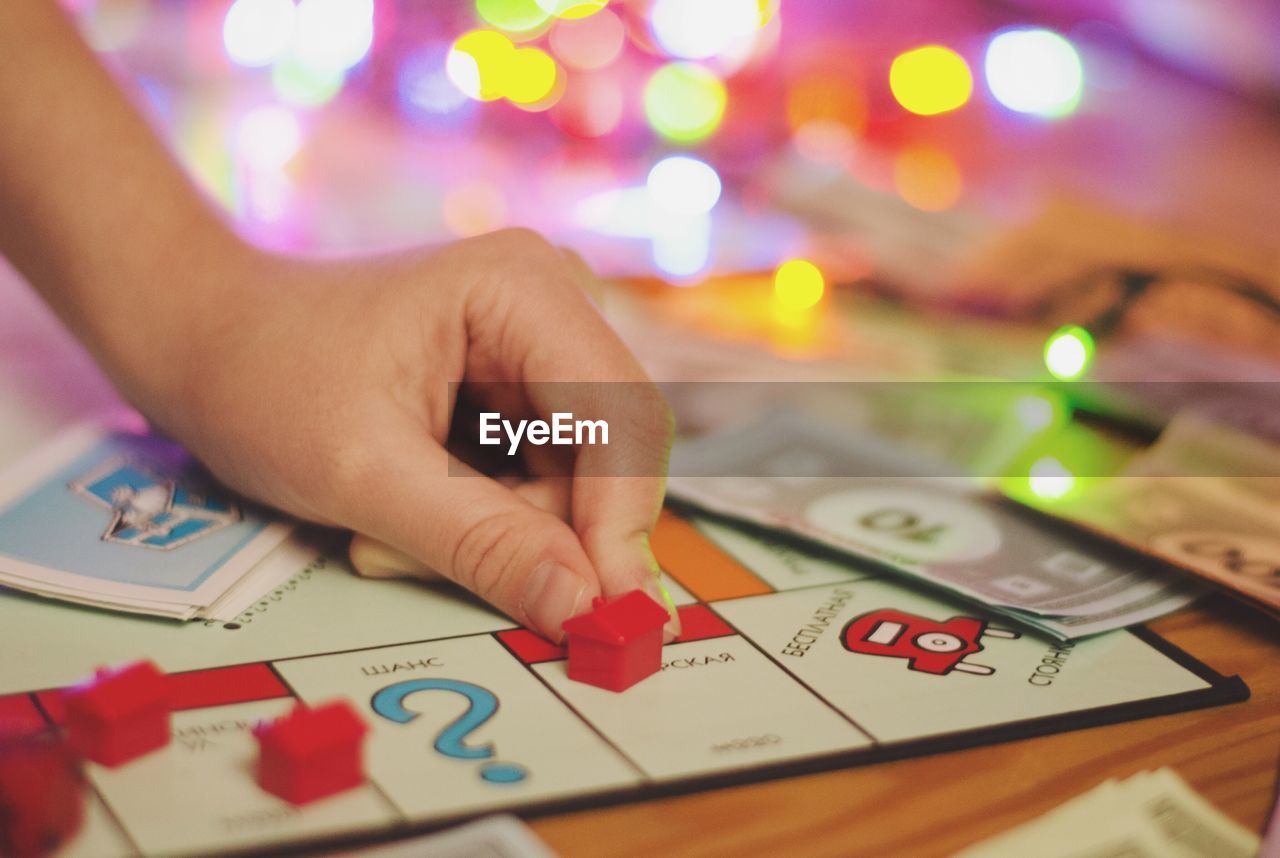 Cropped hand playing game at table