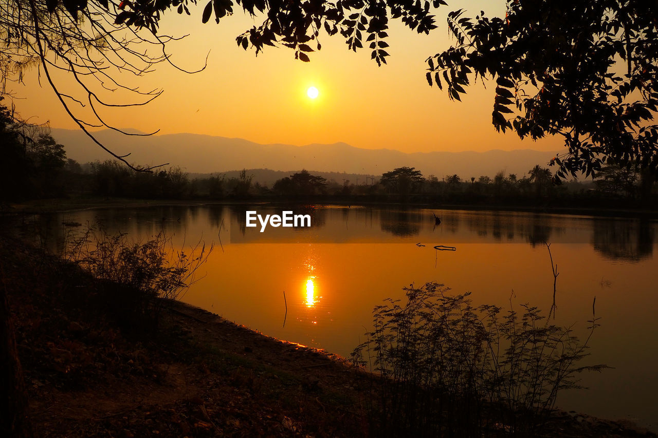 Scenic view of lake against sky during sunset