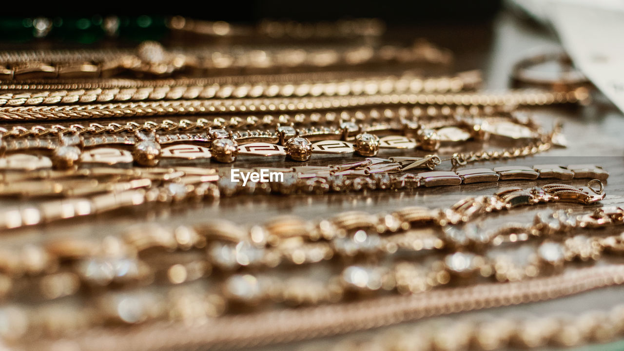 Close-up of gold jewelries on table