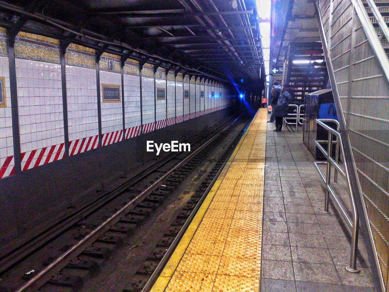 TRAIN ON RAILROAD STATION PLATFORM