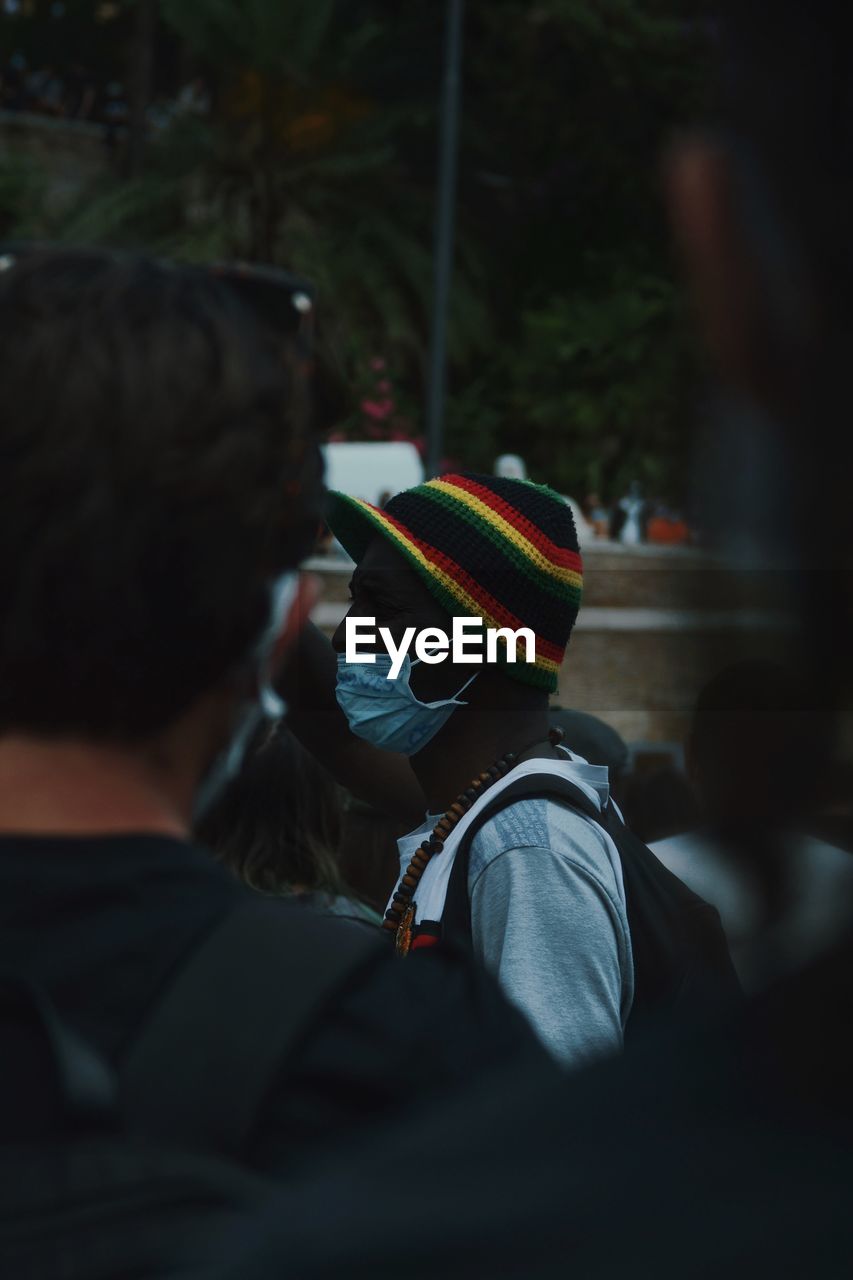 View of man wearing flu mask standing outdoors