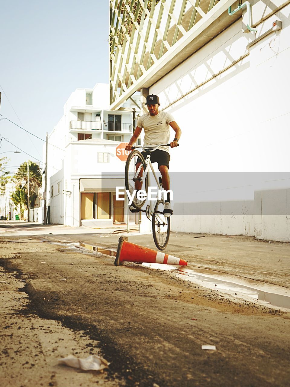 MAN RIDING BICYCLE ON CITY