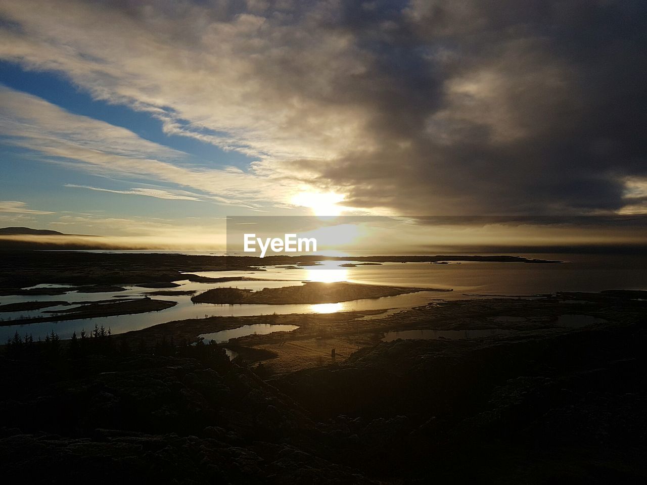 SCENIC VIEW OF SEA AGAINST DRAMATIC SKY DURING SUNSET