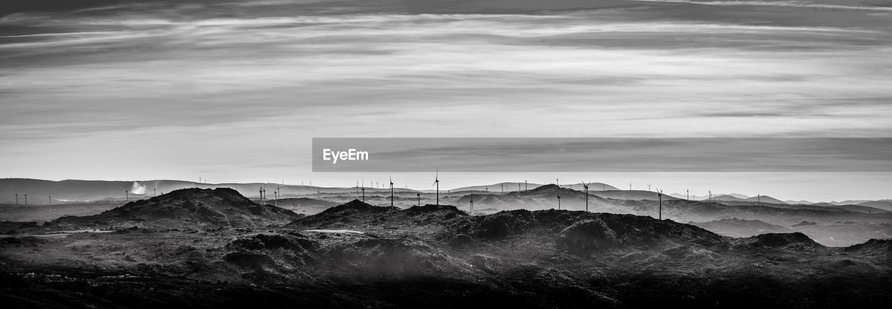 Scenic view of mountains against cloudy sky