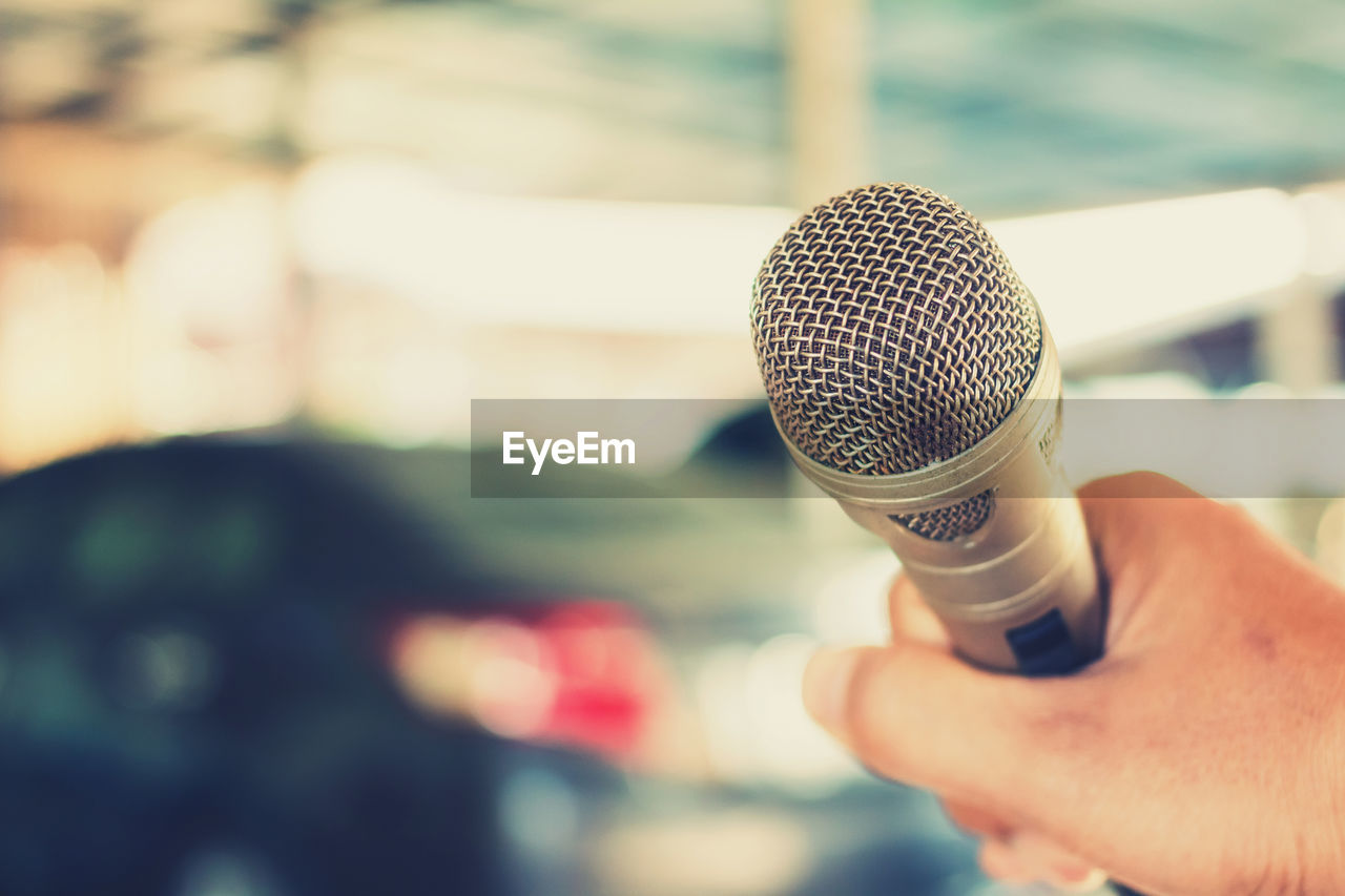 Close-up of hand holding microphone