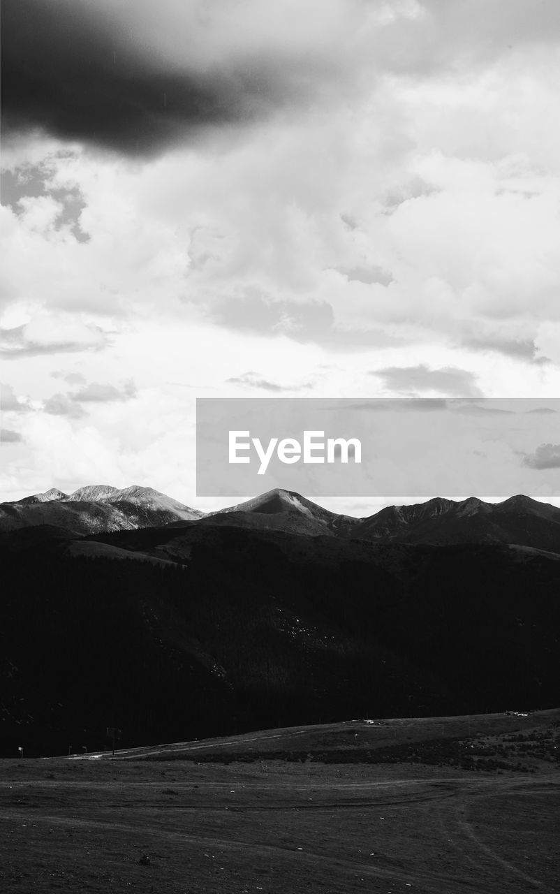 SCENIC VIEW OF LANDSCAPE AND MOUNTAINS AGAINST SKY