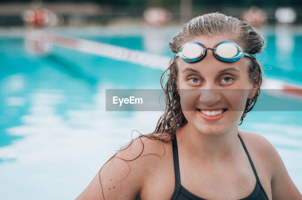 Portrait of smiling young woman in swimming in pool