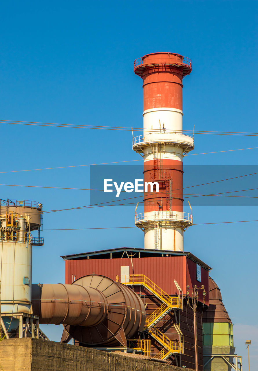 LOW ANGLE VIEW OF SMOKE STACK AGAINST SKY