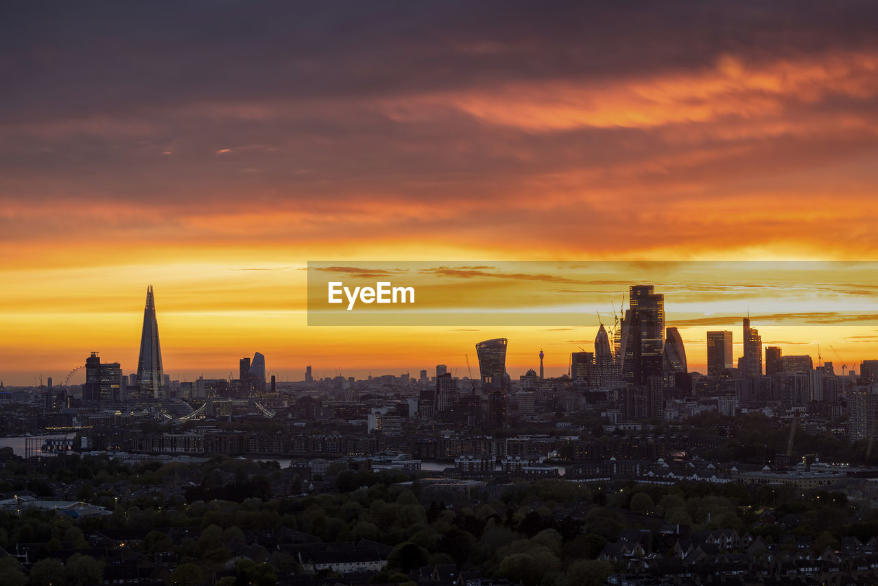 high angle view of buildings in city against sky during sunset