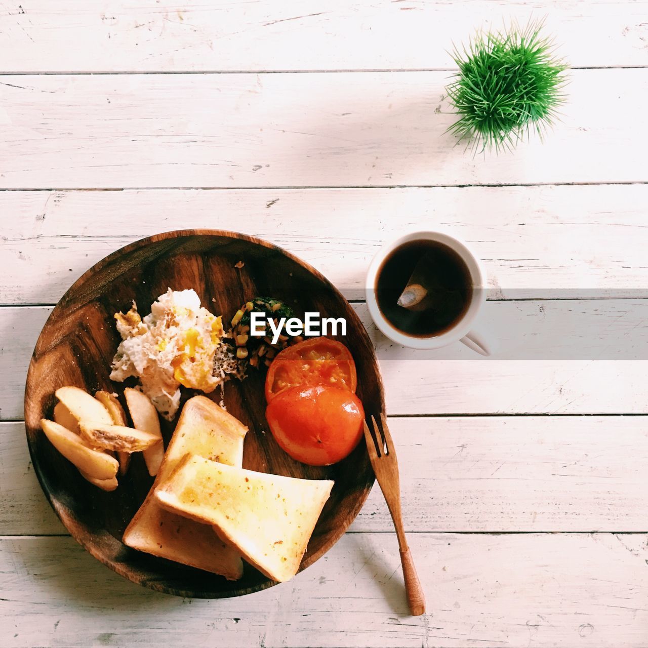 Directly above shot of food in plate on wooden plate