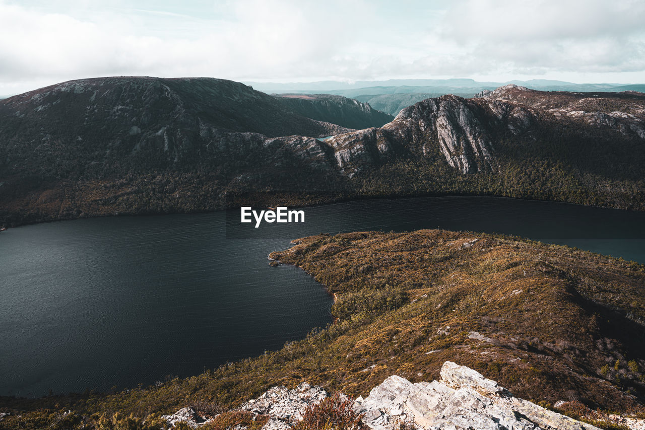 Scenic view of dove lake by mountain against sky