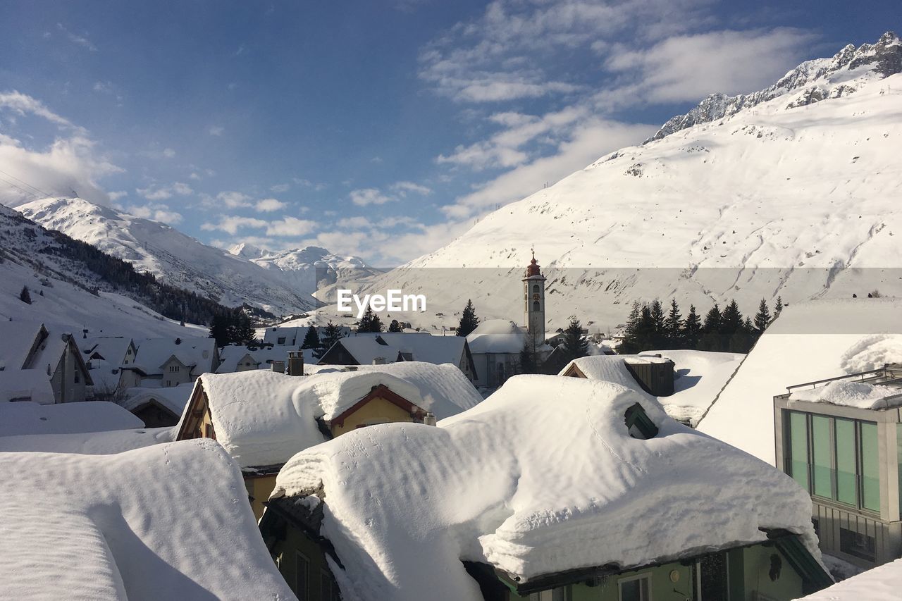 Panoramic view of snow covered mountains against sky