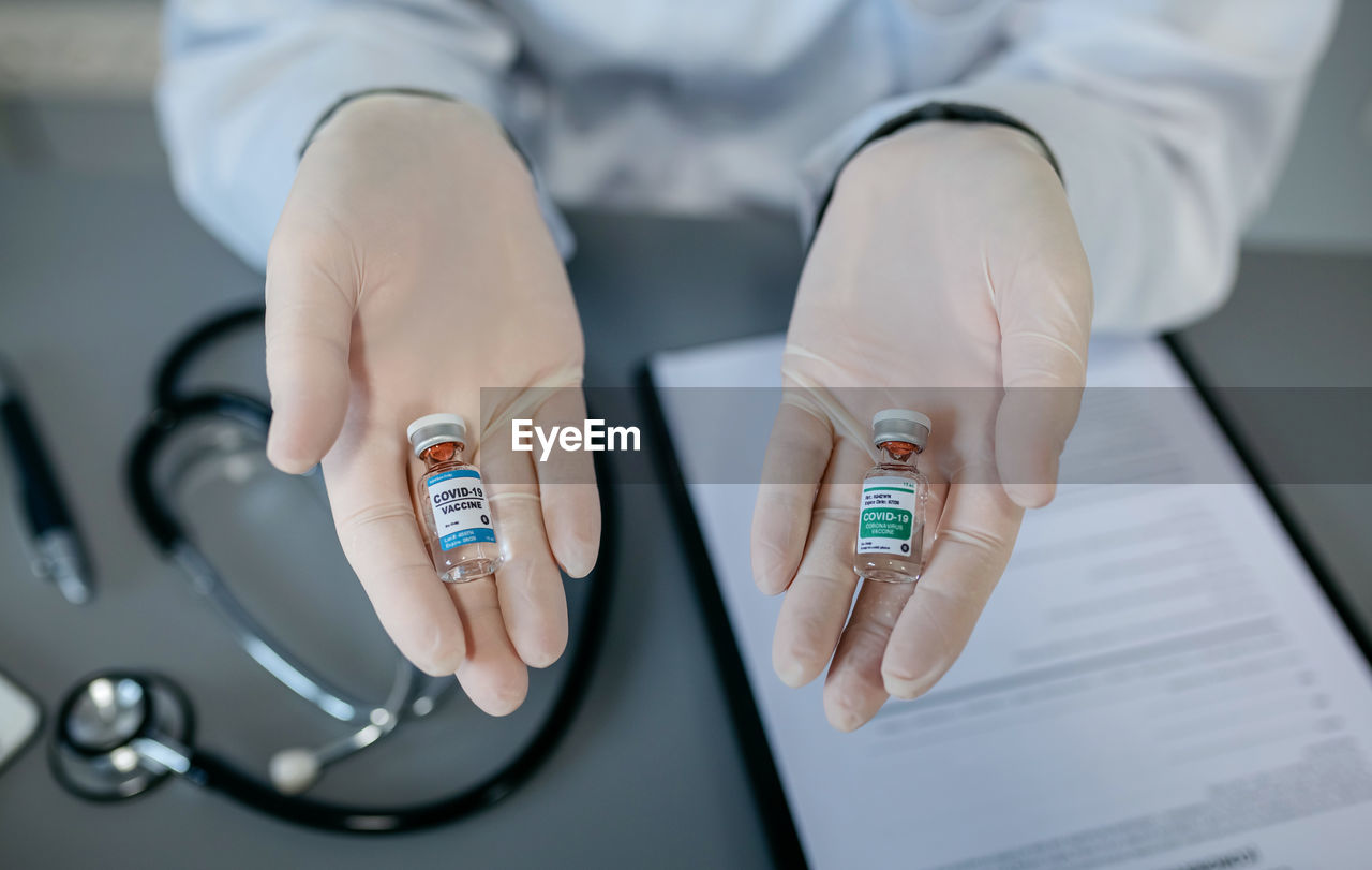 Cropped hands of doctor holding medicines