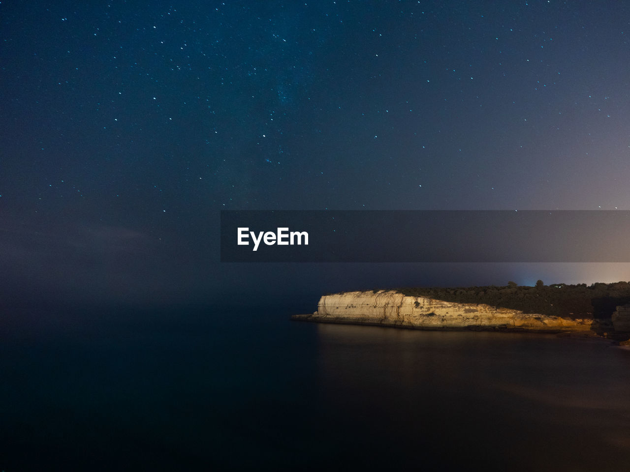 Scenic view of sea against sky at night