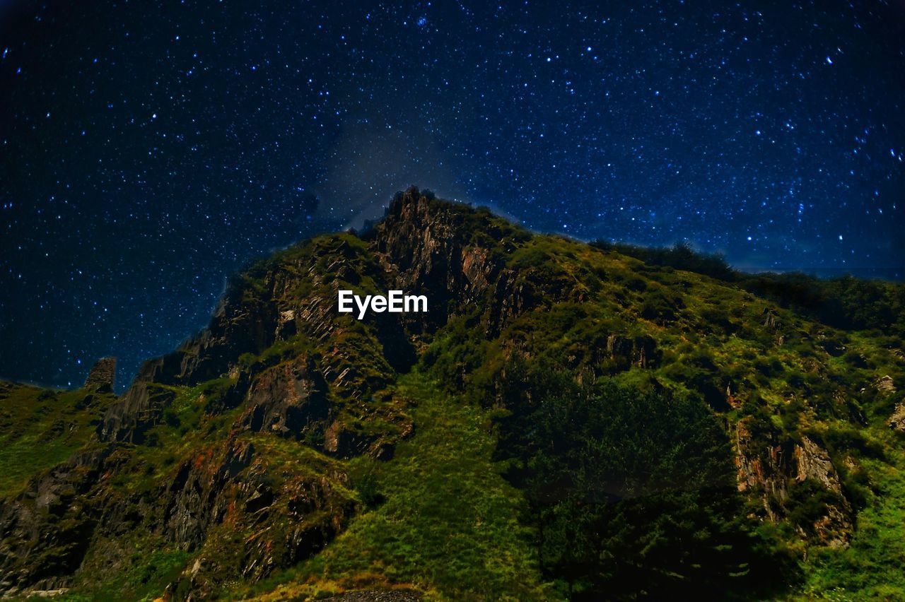 Low angle view of mountain against sky at night