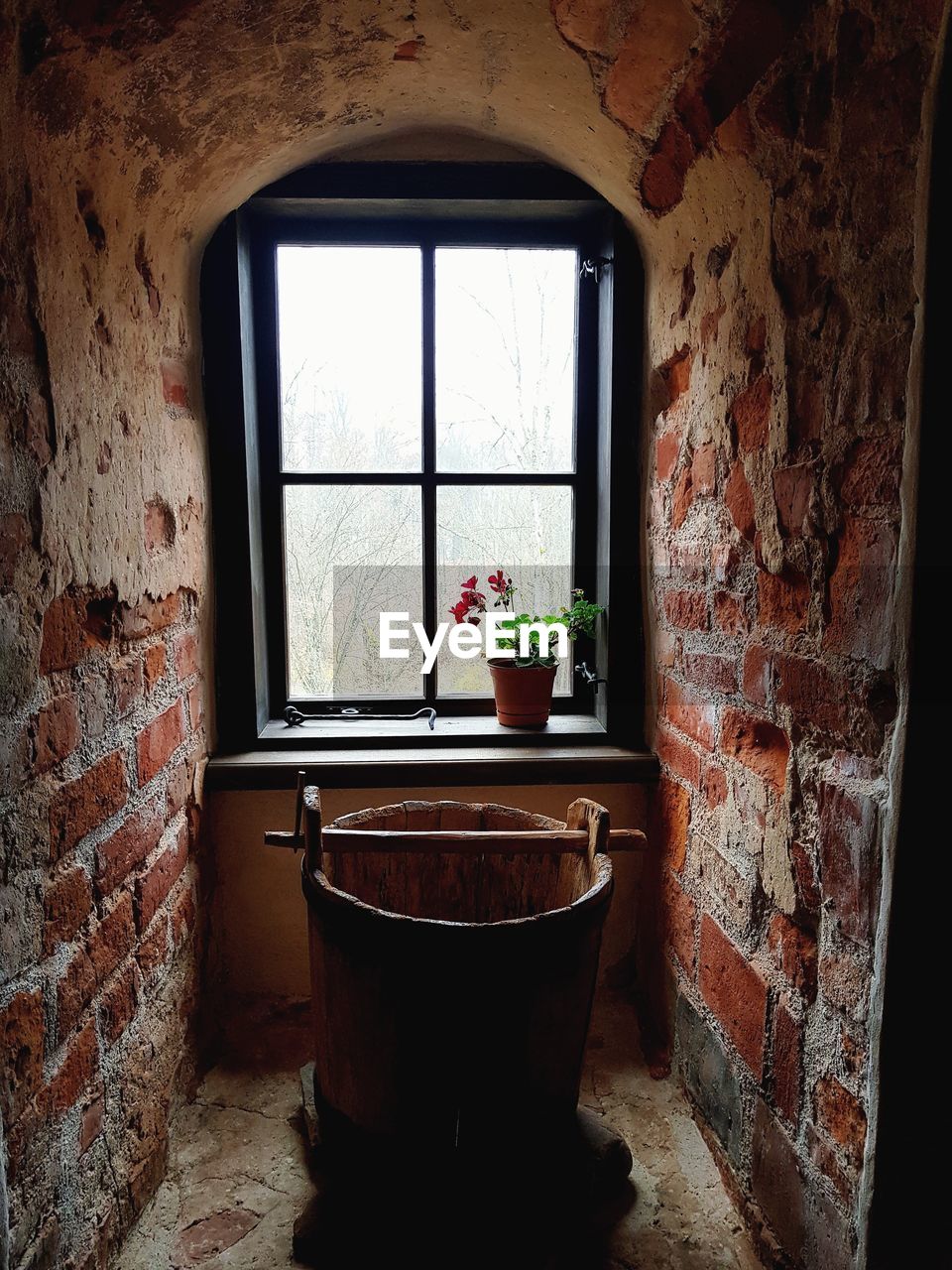 POTTED PLANTS ON WINDOW SILL AGAINST WALL