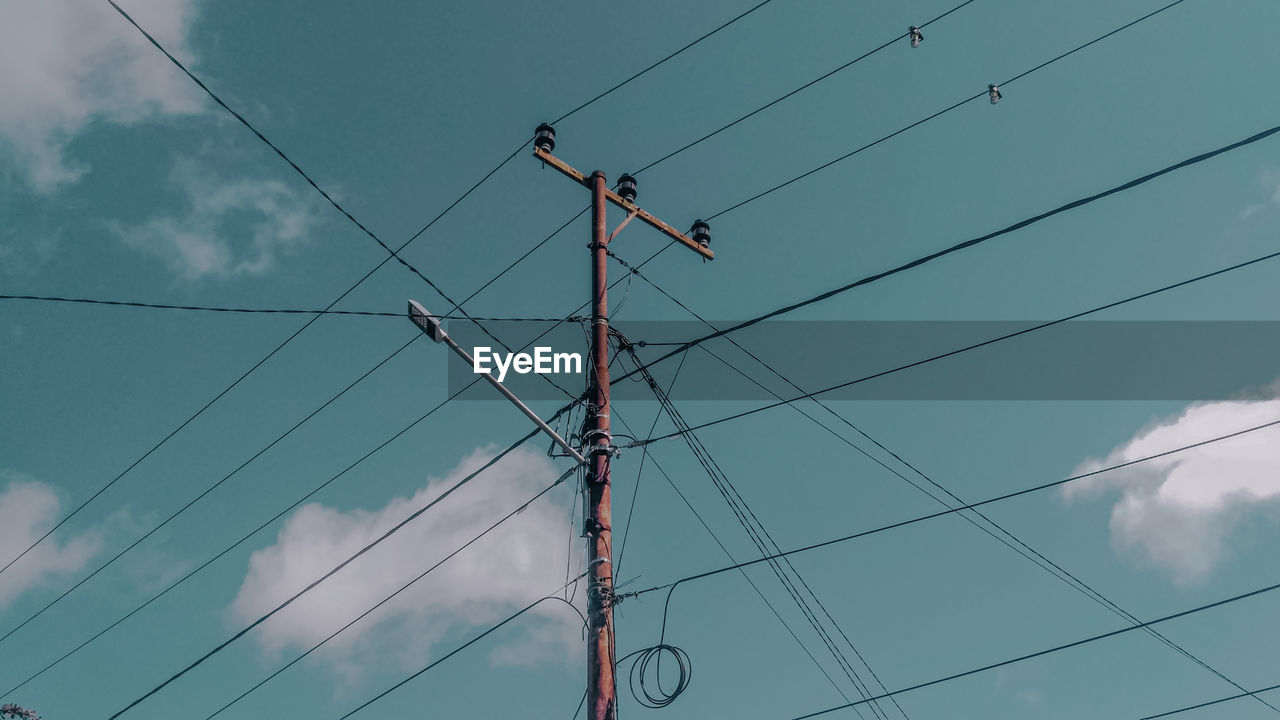 Low angle view of power lines against sky