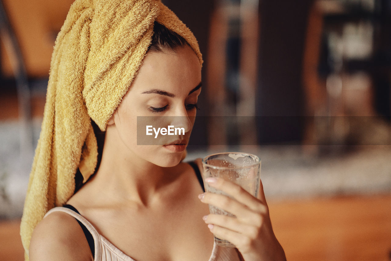 Young beautiful woman with a towel on her head.