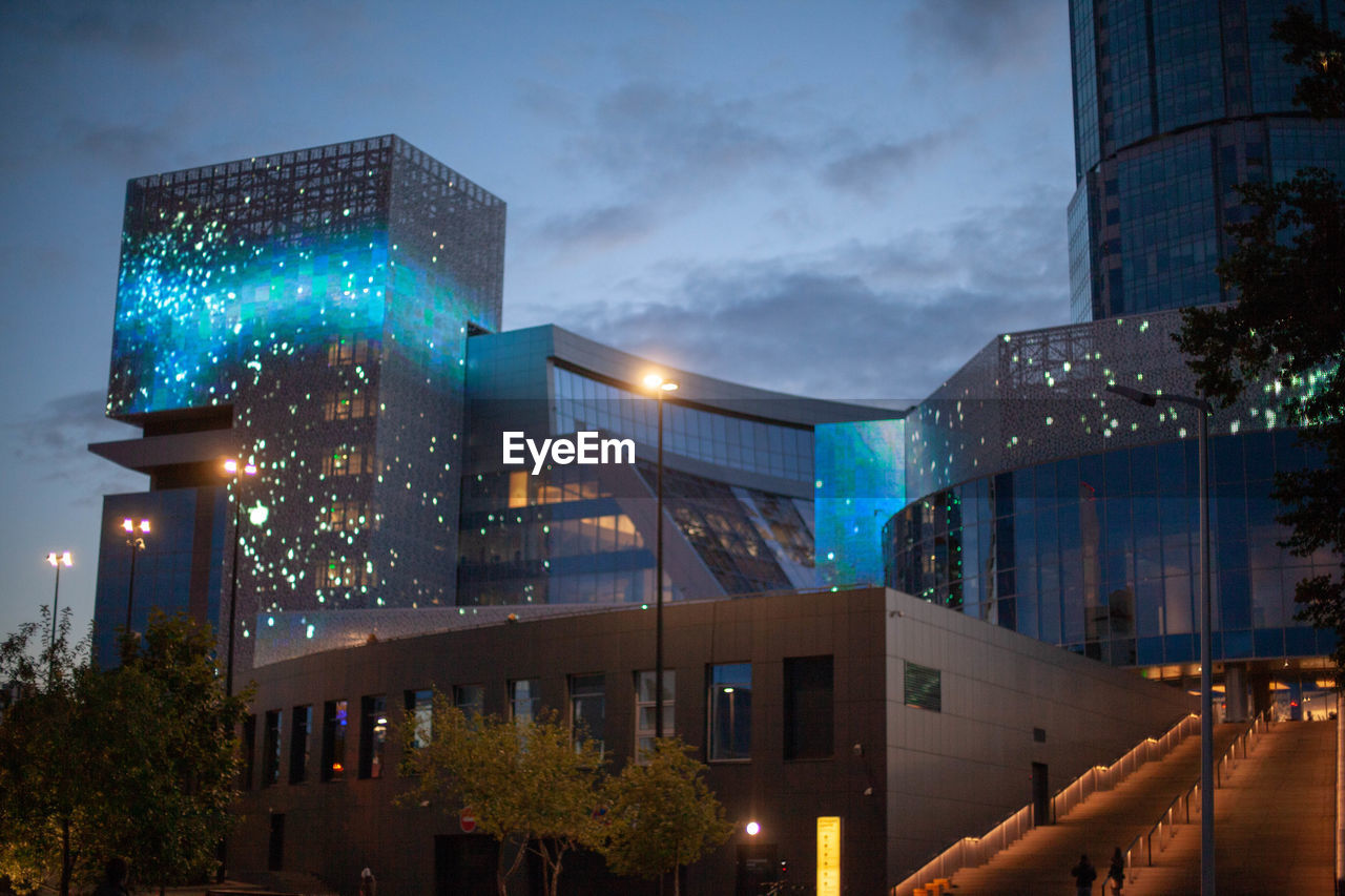 LOW ANGLE VIEW OF ILLUMINATED BUILDINGS AGAINST SKY