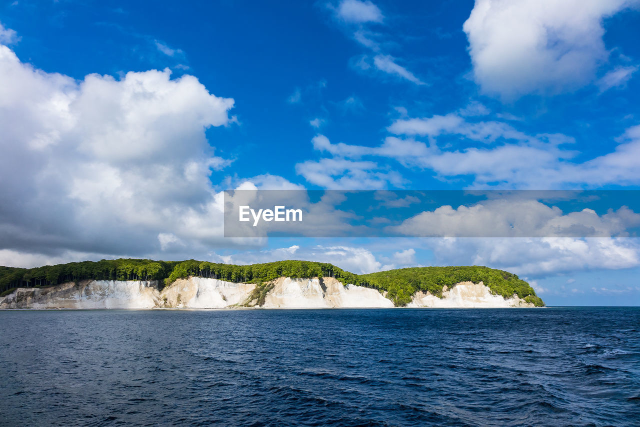 Scenic view of mountain in baltic sea against blue sky