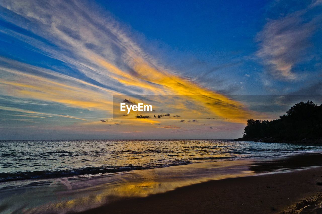 Scenic view of beach against sky during sunset