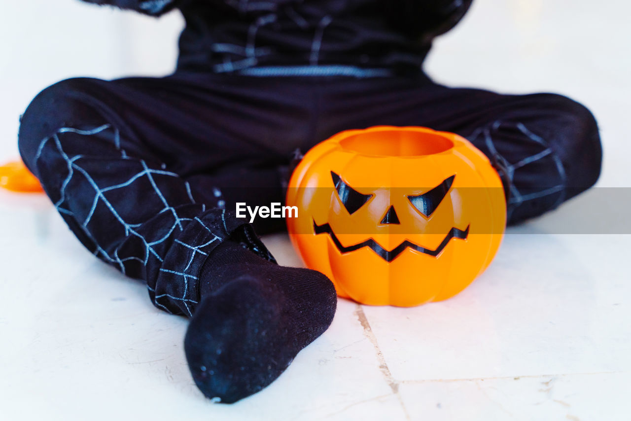 CLOSE-UP OF HUMAN FACE WITH PUMPKIN ON PAPER