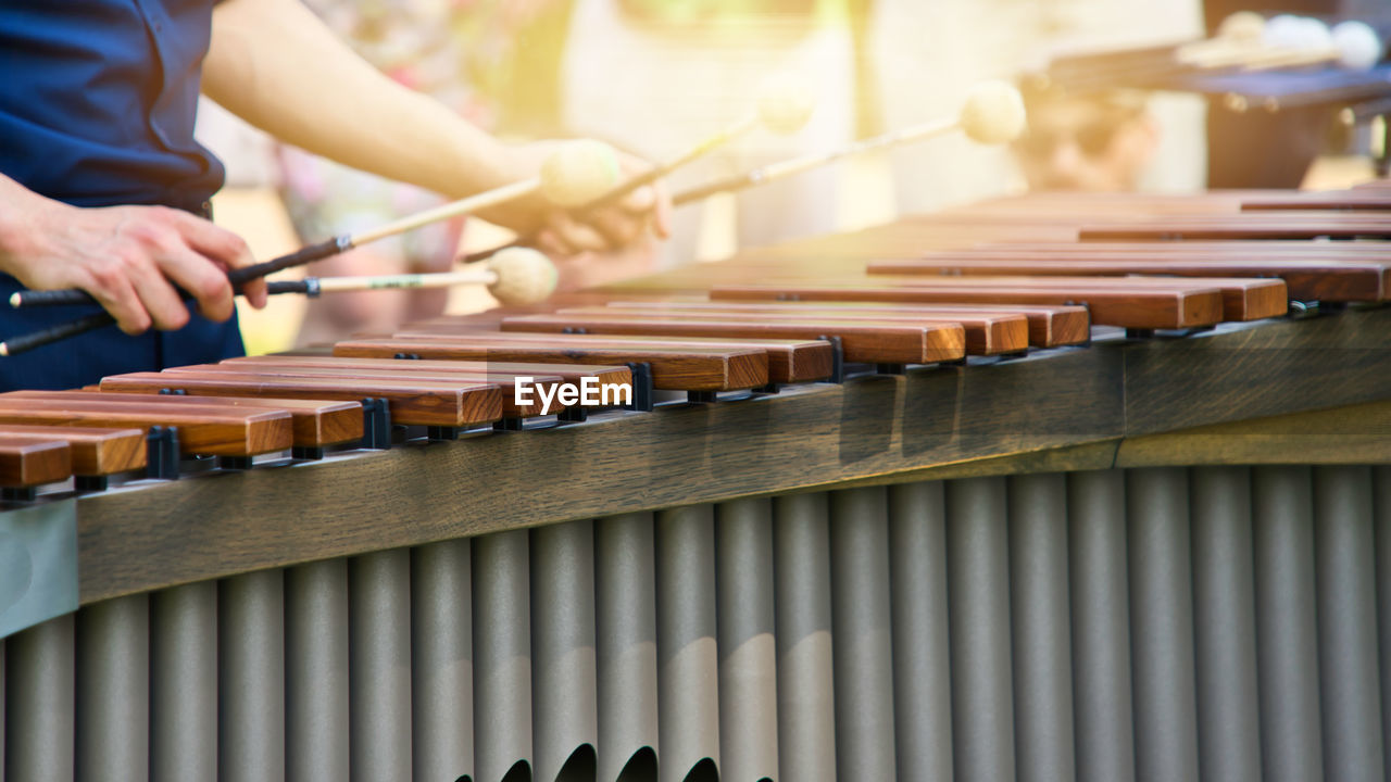 Musician playing on a marimba, an instrument from the group of xylophones